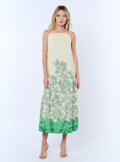 Load image 1 in gallery view. Woman wearing a green and white floral dress on a white background