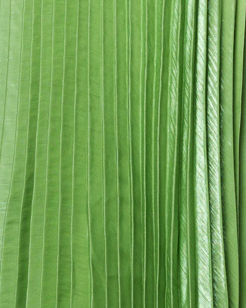 Woman wearing a green pleated dress on a white background