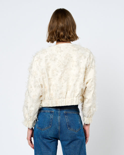 Load image 1 in gallery view. Person wearing a cream sweater and blue jeans on a white background