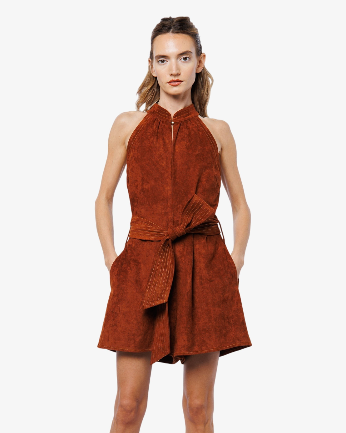 Woman wearing a brown suede dress on a white background