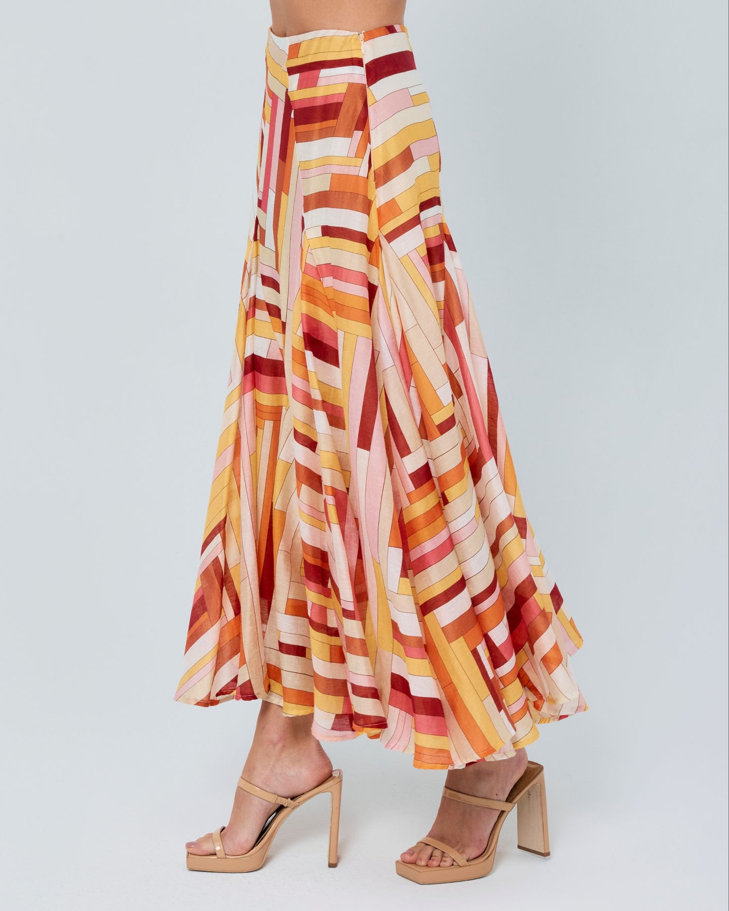 Woman wearing a colorful striped outfit on a white background