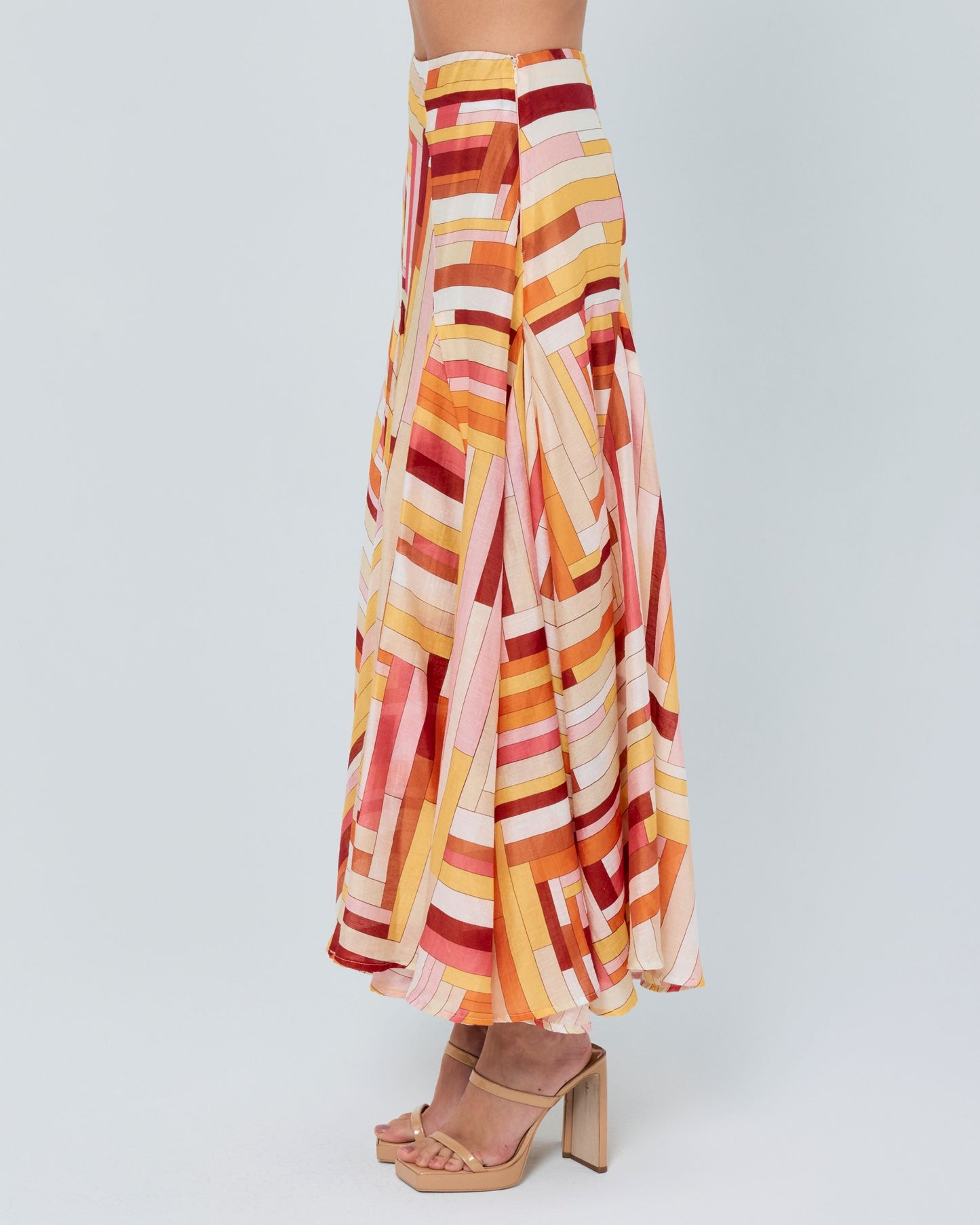 Woman wearing a colorful striped outfit on a white background