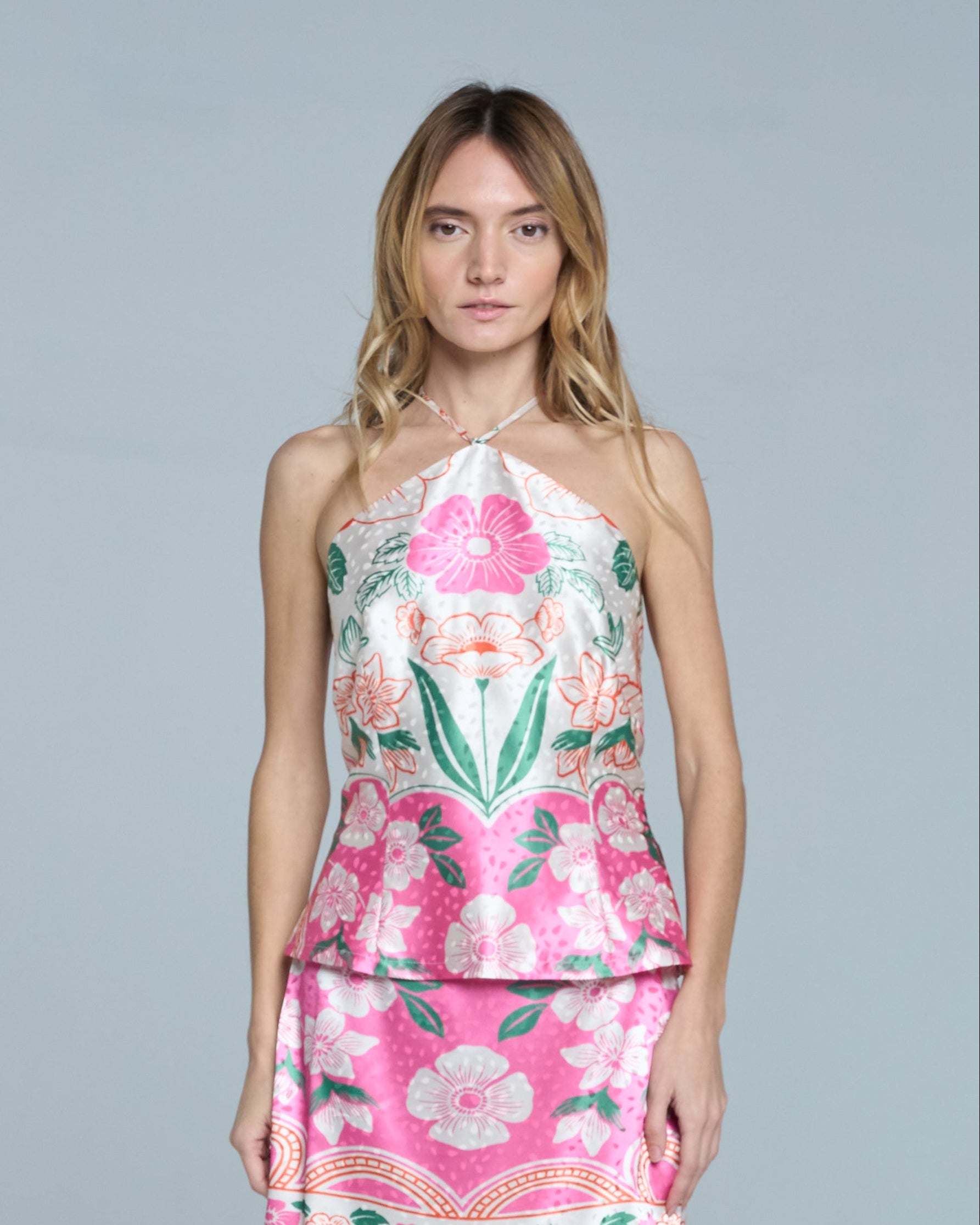 Woman wearing a floral dress on a light gray background