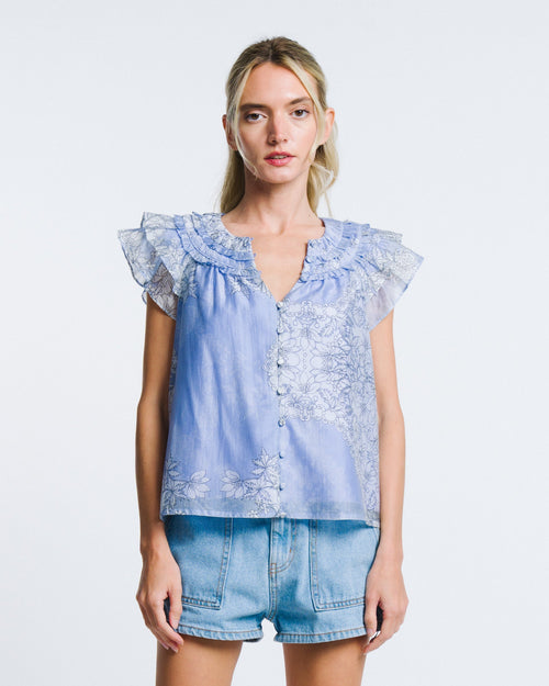 Load image 1 in gallery view. Woman wearing a light blue denim top with lace details and matching shorts on a white background