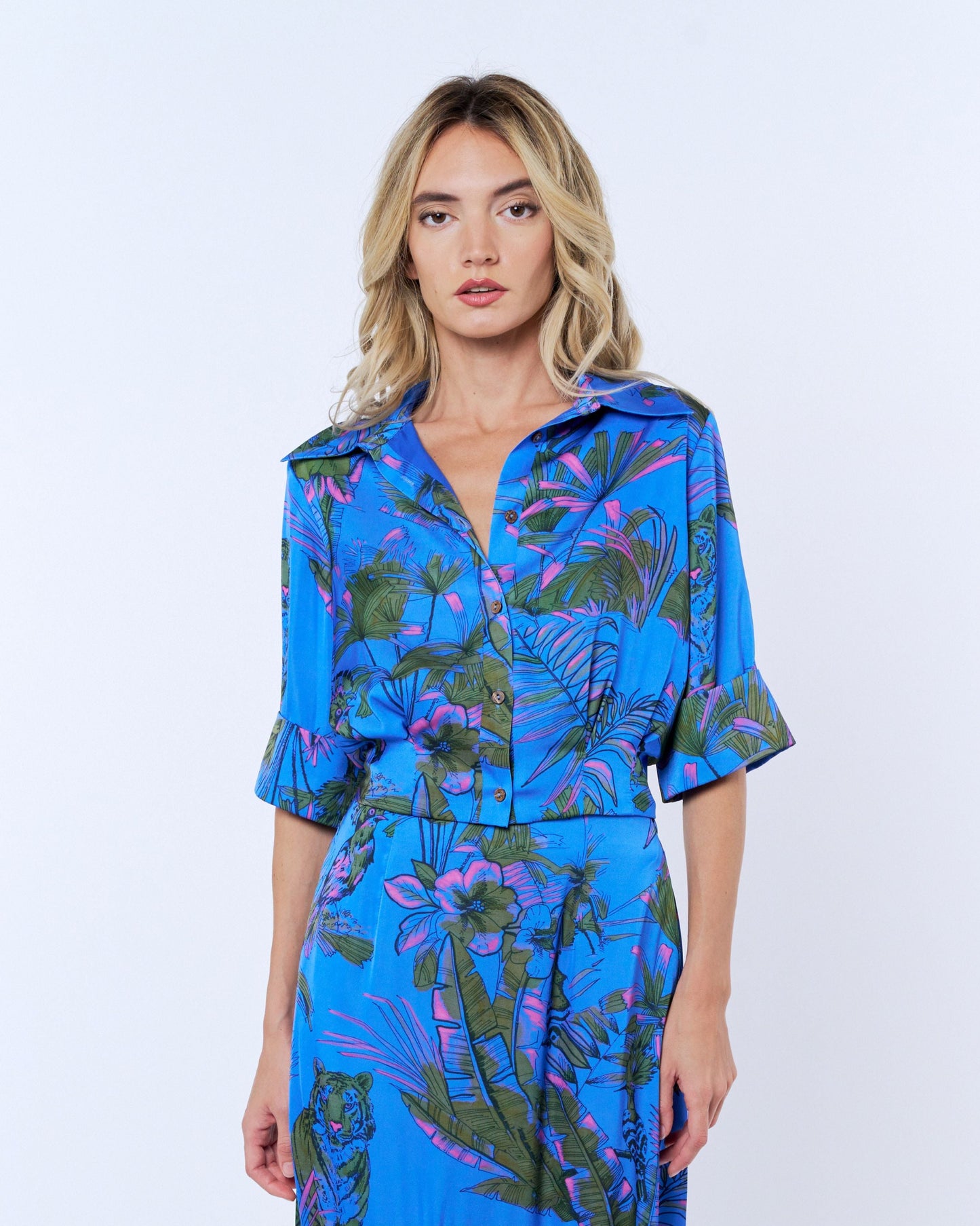 Woman wearing a blue floral dress on a white background