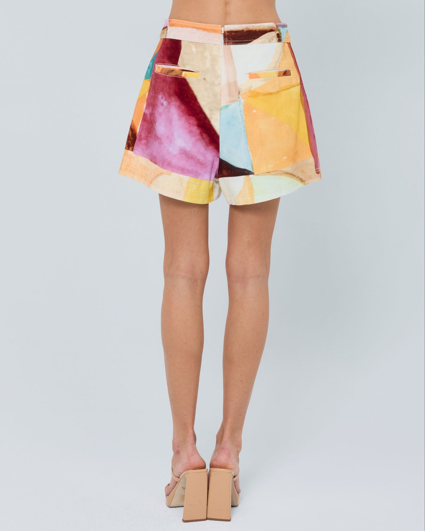 Woman wearing a colorful outfit with a white background
